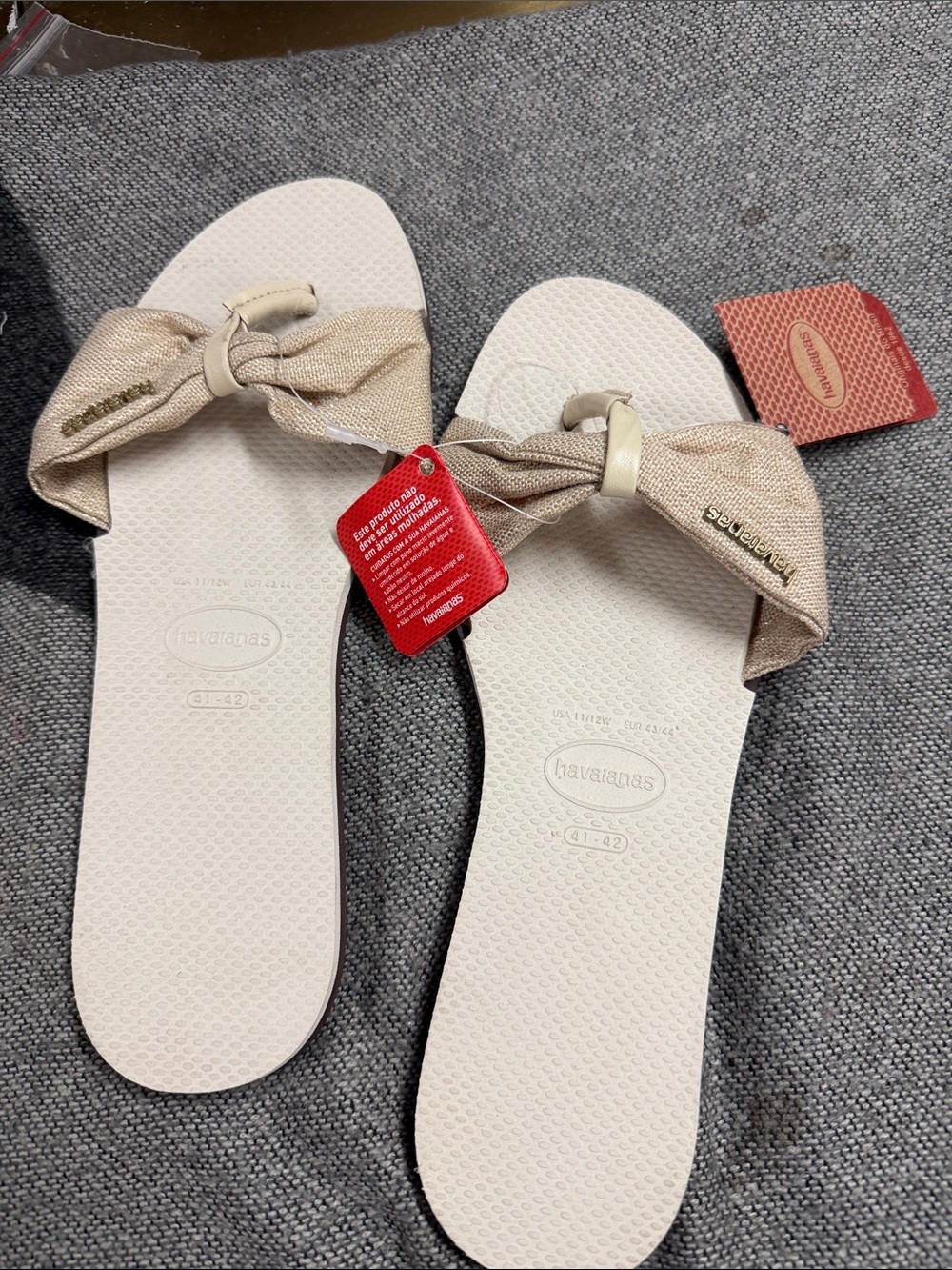 Havaianas Women’s Cream Flip Flop Sandals with Gold Bow Accent